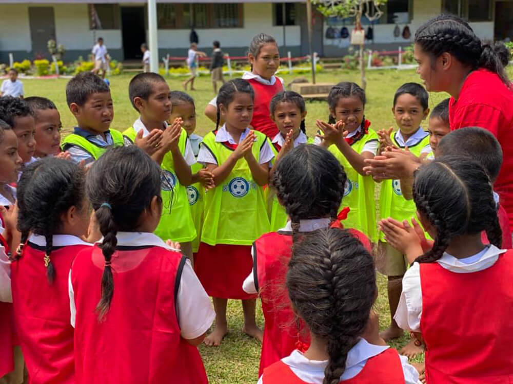 Young children play football in Tonga