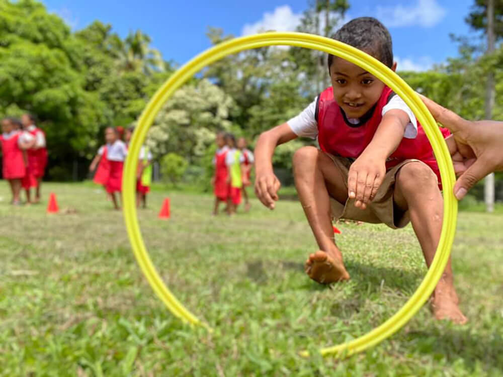 Young children play football in Tonga