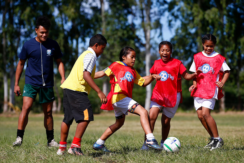 Young children play football in Tonga