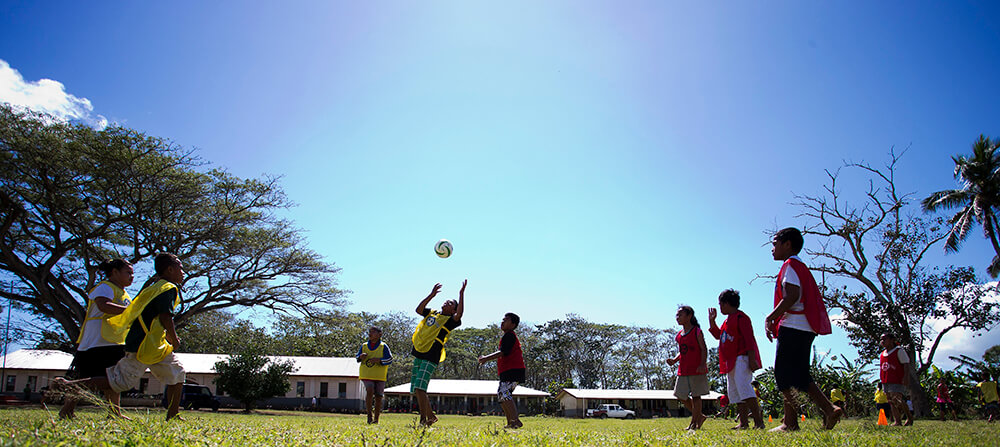 Young children play football in Tonga