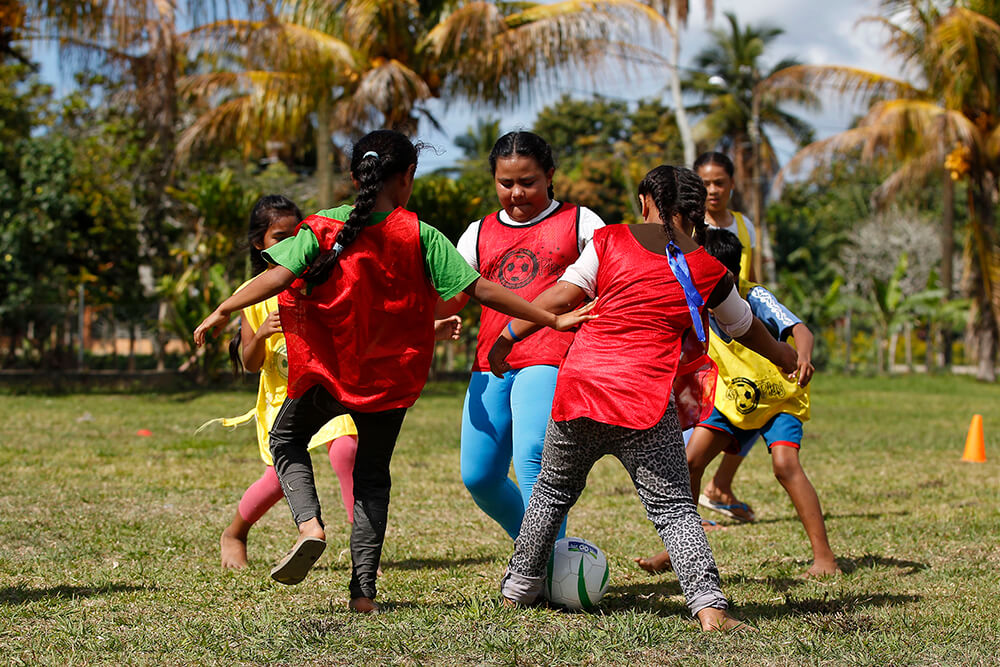 Young children play football in Tonga