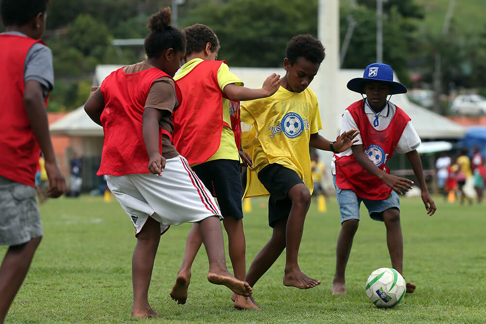 Young children play football in Vanuatu