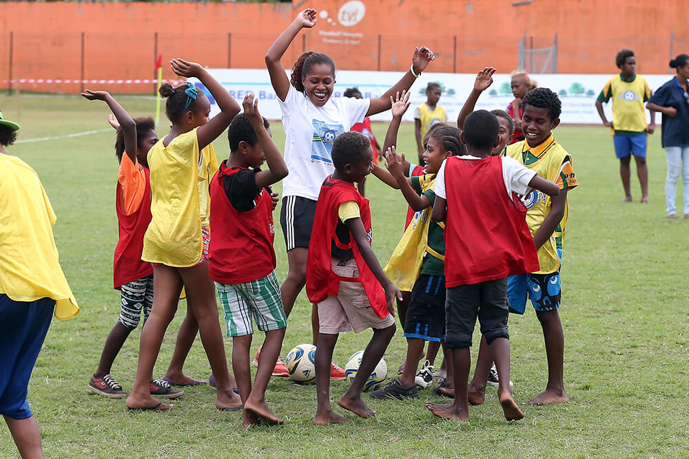 Young children play football in Vanuatu