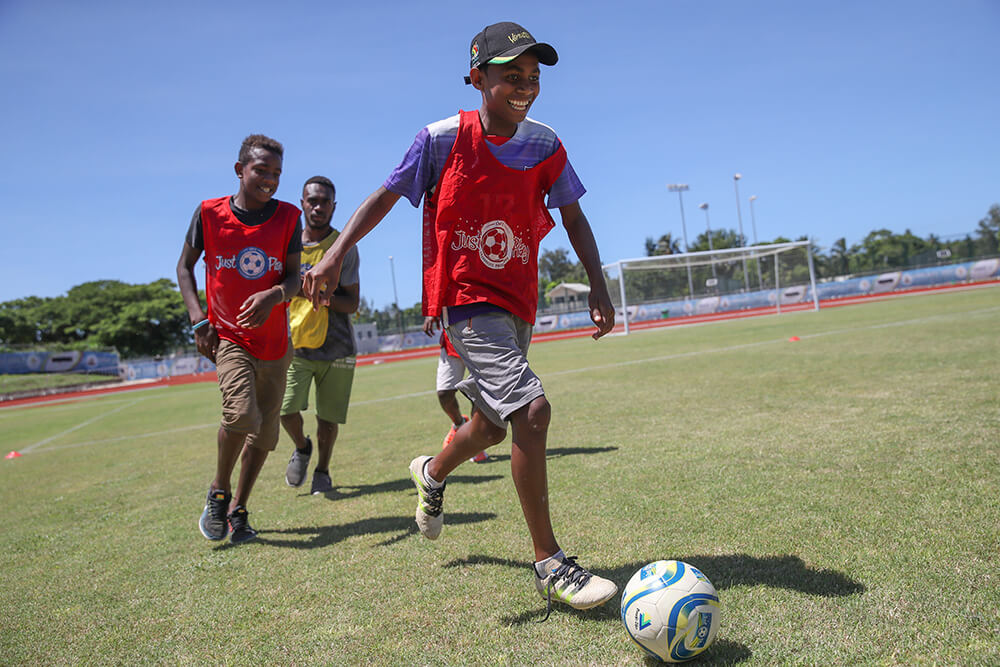 Young children play football in Vanuatu