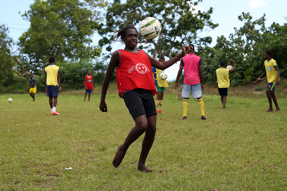 Young children play football in Vanuatu