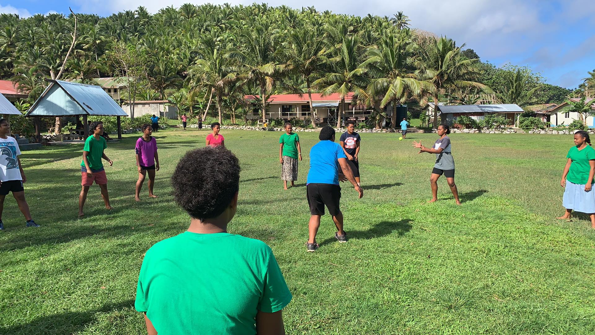 Young people play cricket in Fiji