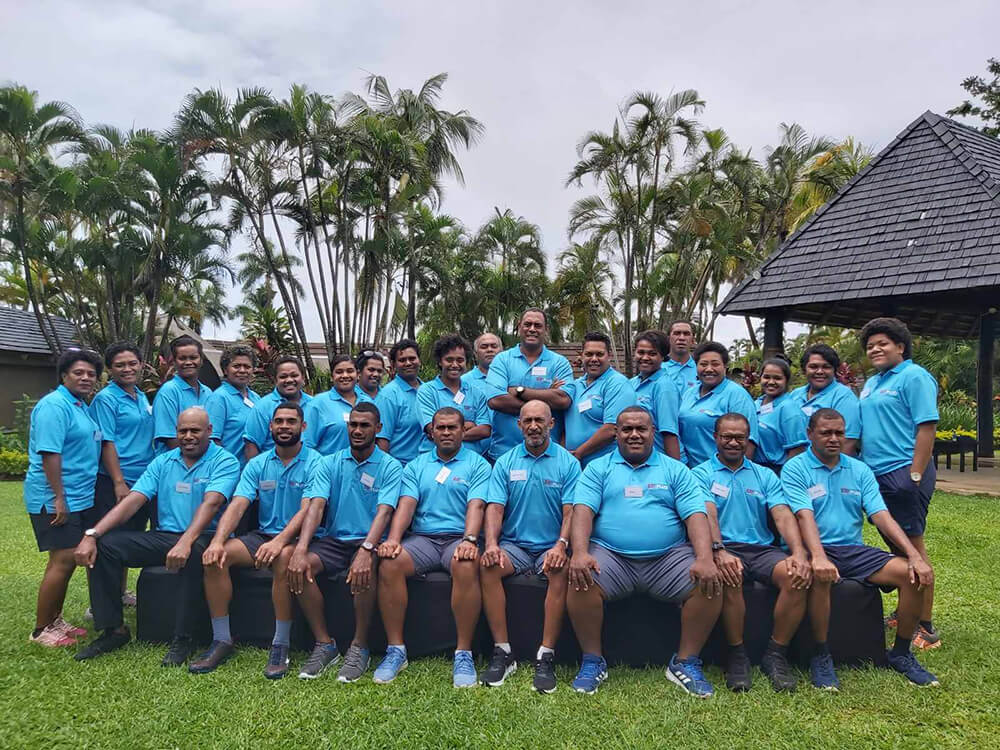 Volunteers and community members playing rugby in Fiji