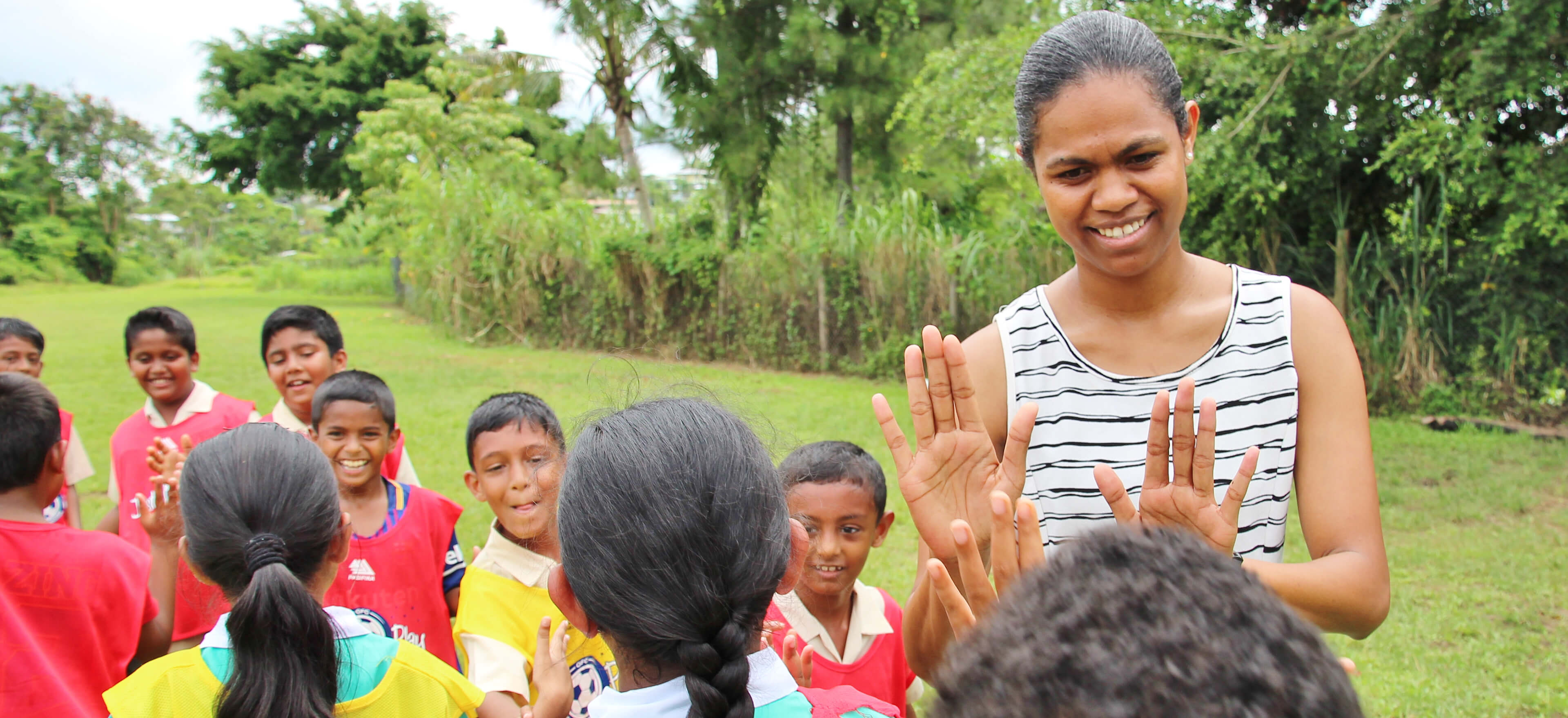 woman talking to Fijian children