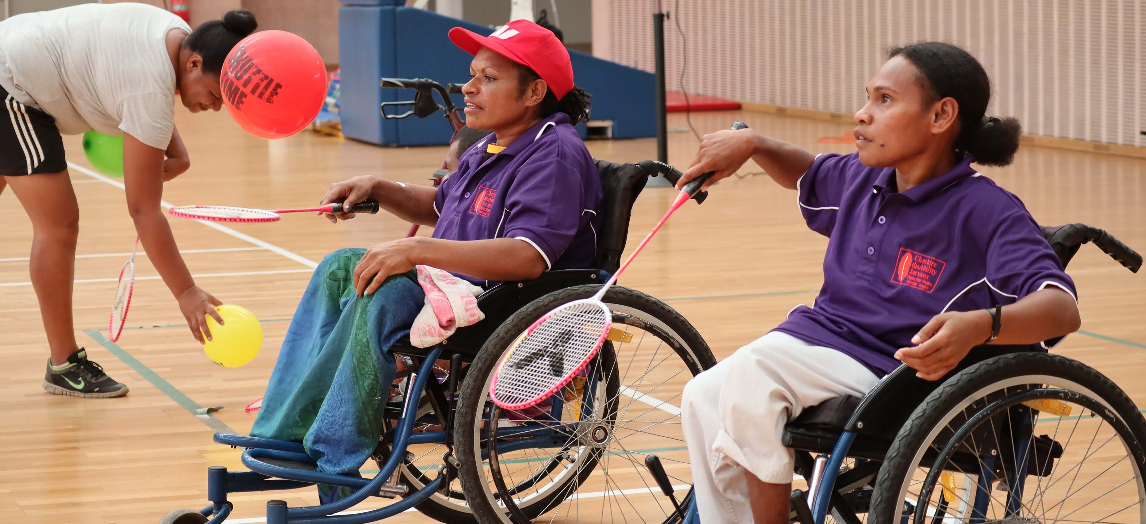 Women in Papua New Guinea playing badminton in wheelchairs