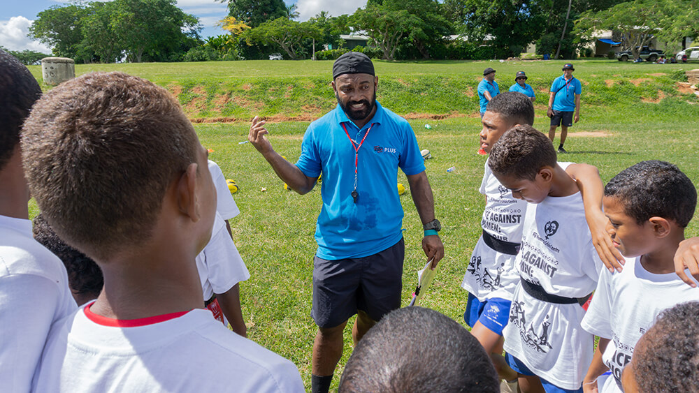 Volunteers and community members playing rugby in Fiji