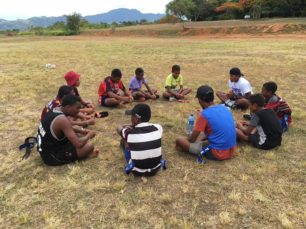 Volunteers and community members playing rugby in Fiji