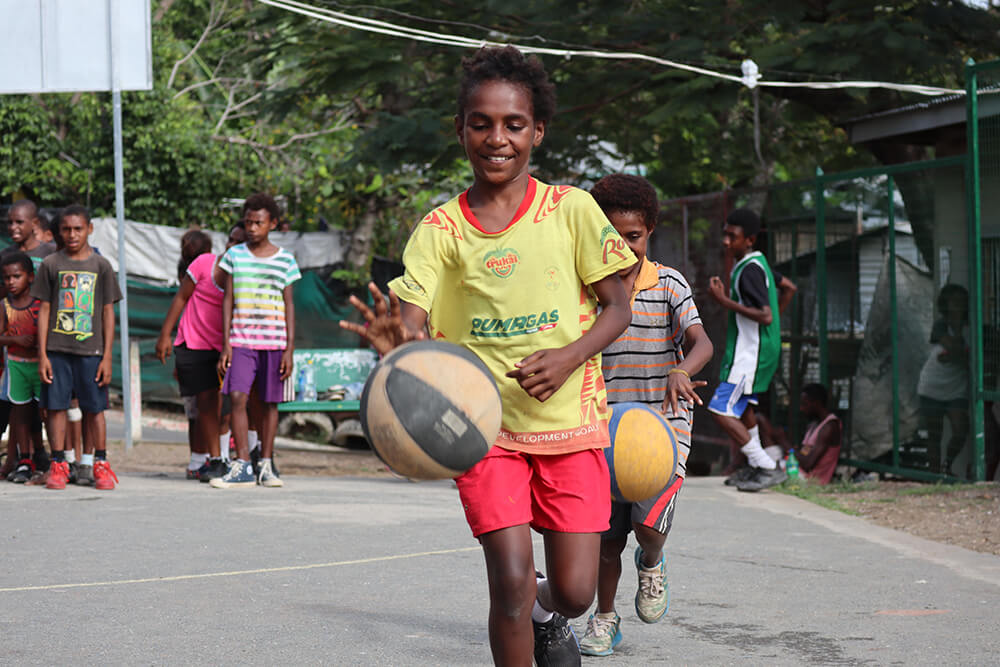 Young people play basketball in Papua New Guinea