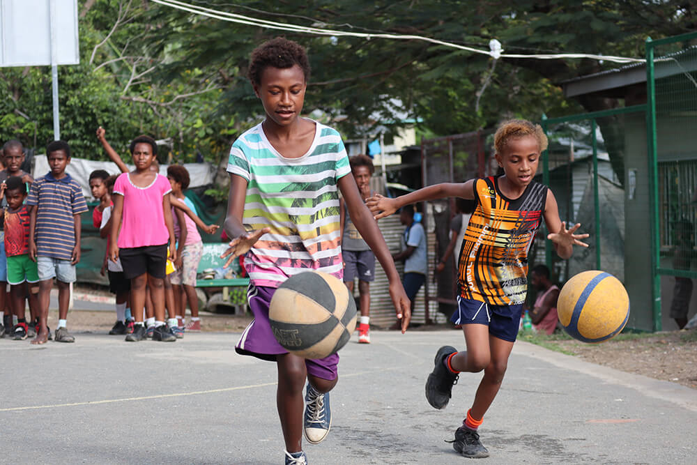 Young people play basketball in Papua New Guinea