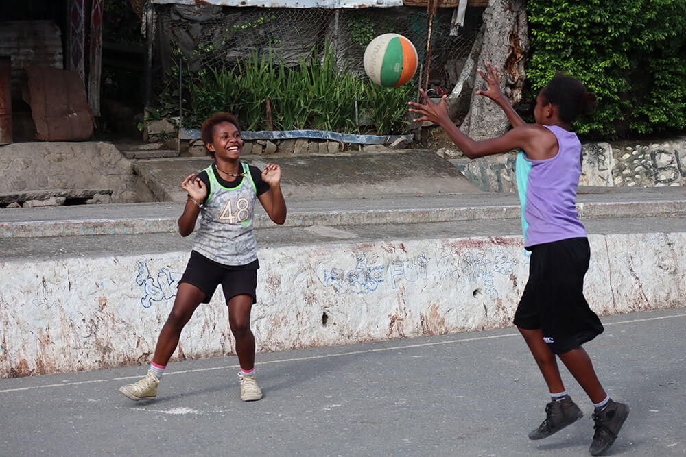 Young people play basketball in Papua New Guinea