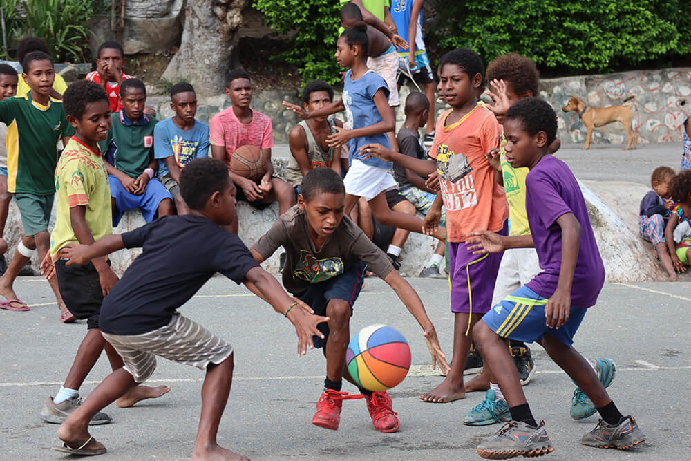 Young people play basketball in Papua New Guinea