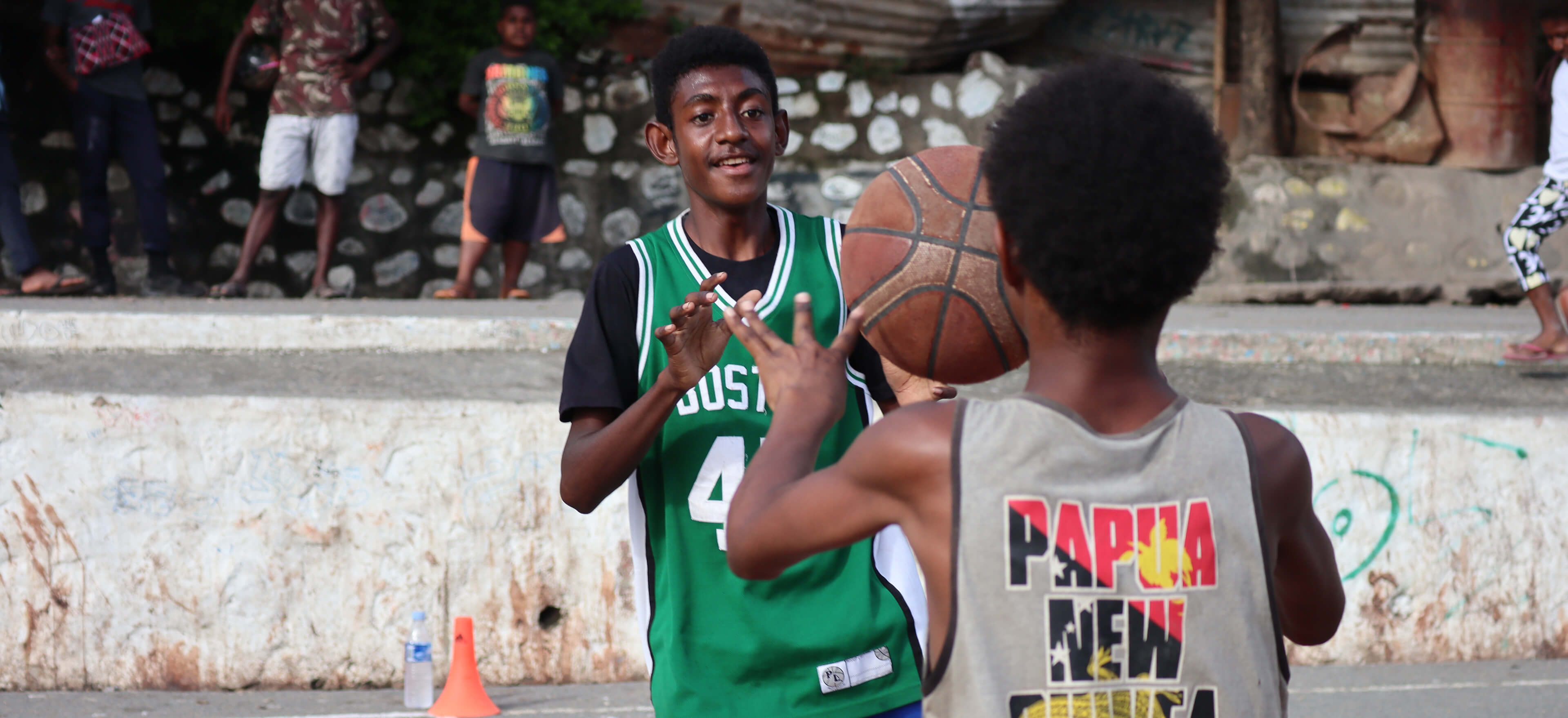 two boys playing basketball
