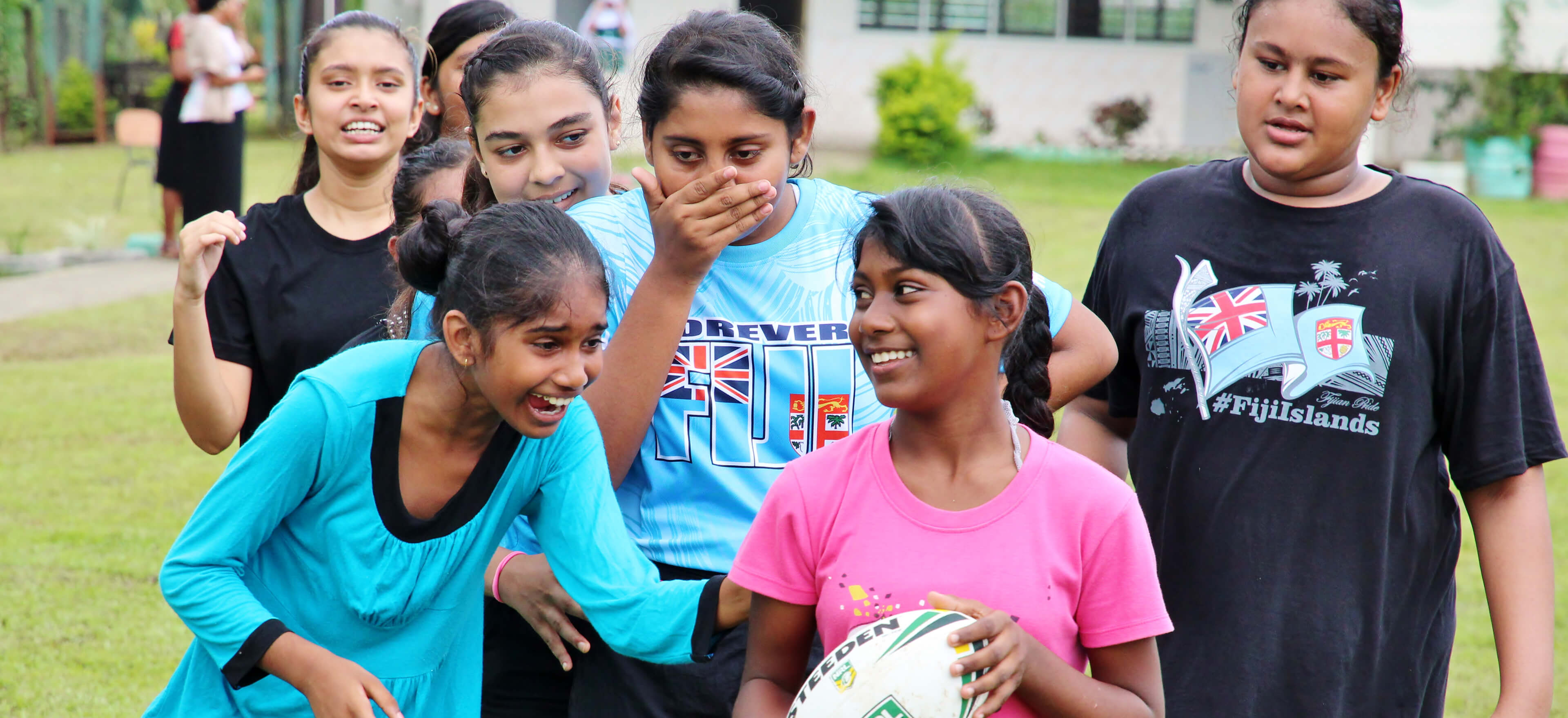 girls holding rugby ball