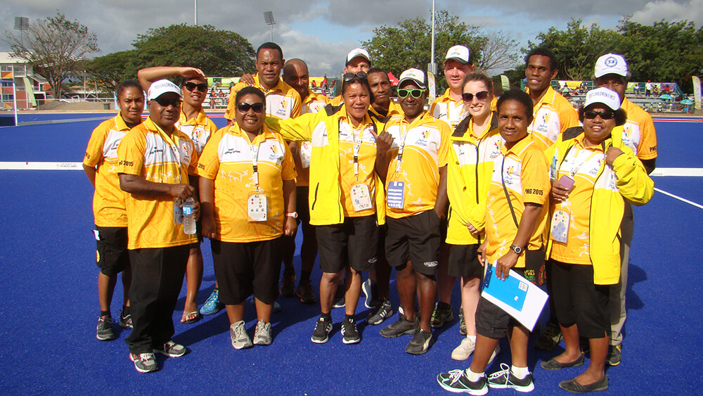 Community members playing hockey in Papua New Guinea