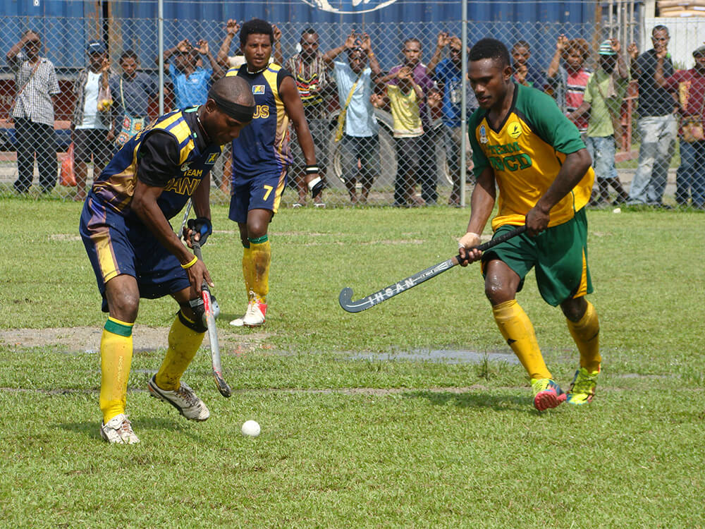 Community members playing hockey in Papua New Guinea