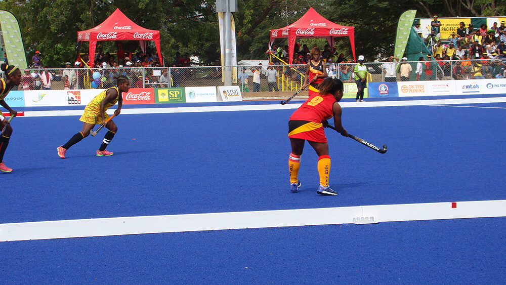 Community members playing hockey in Papua New Guinea