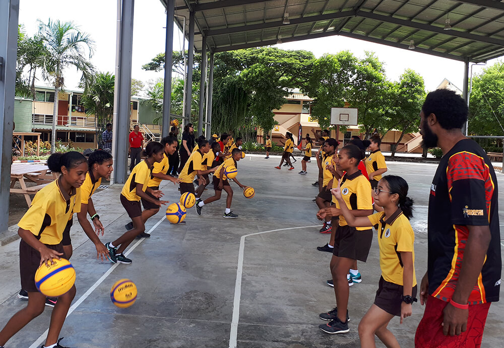 Young people play basketball in Papua New Guinea