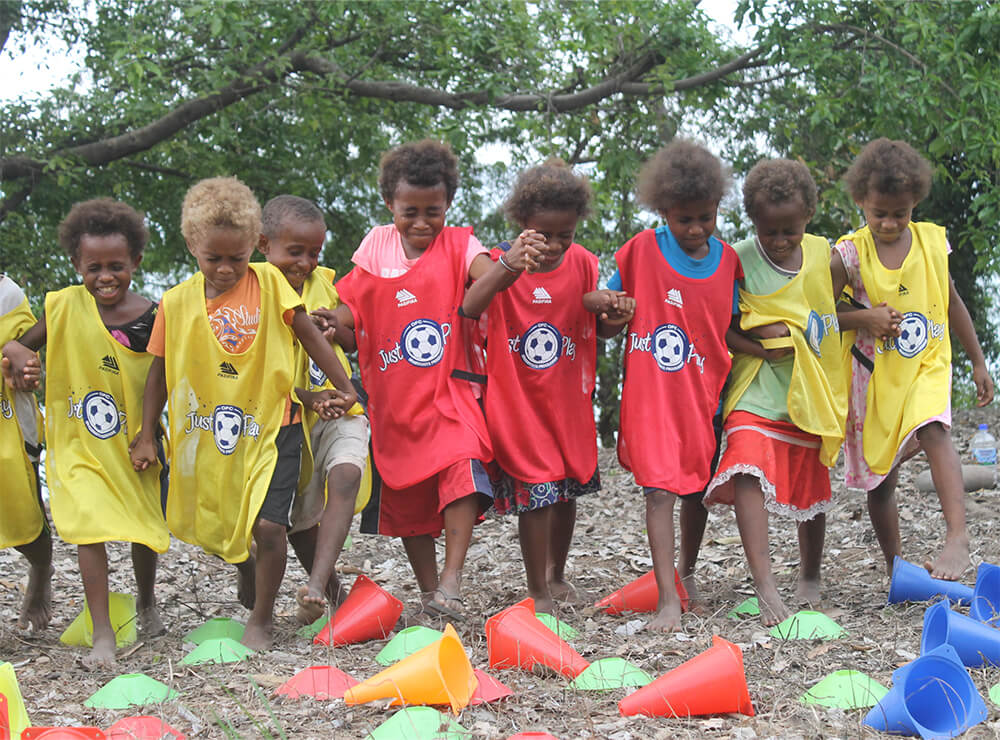 Young children play football in Vanuatu