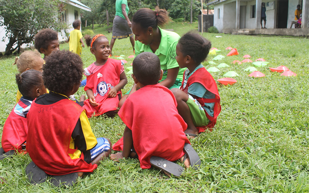 Young children play football in Vanuatu
