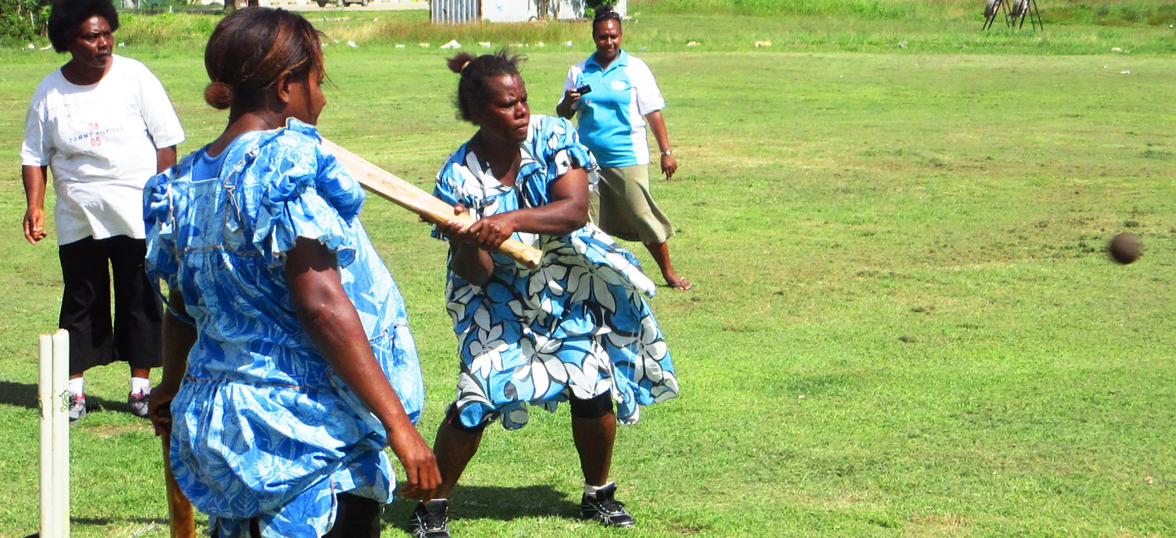 Pacific woman playing cricket