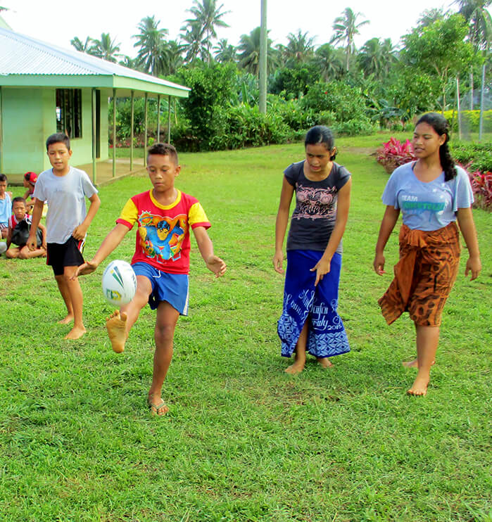 Kids playing with a rugby ball