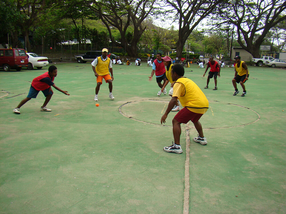 Community members playing hockey in Papua New Guinea
