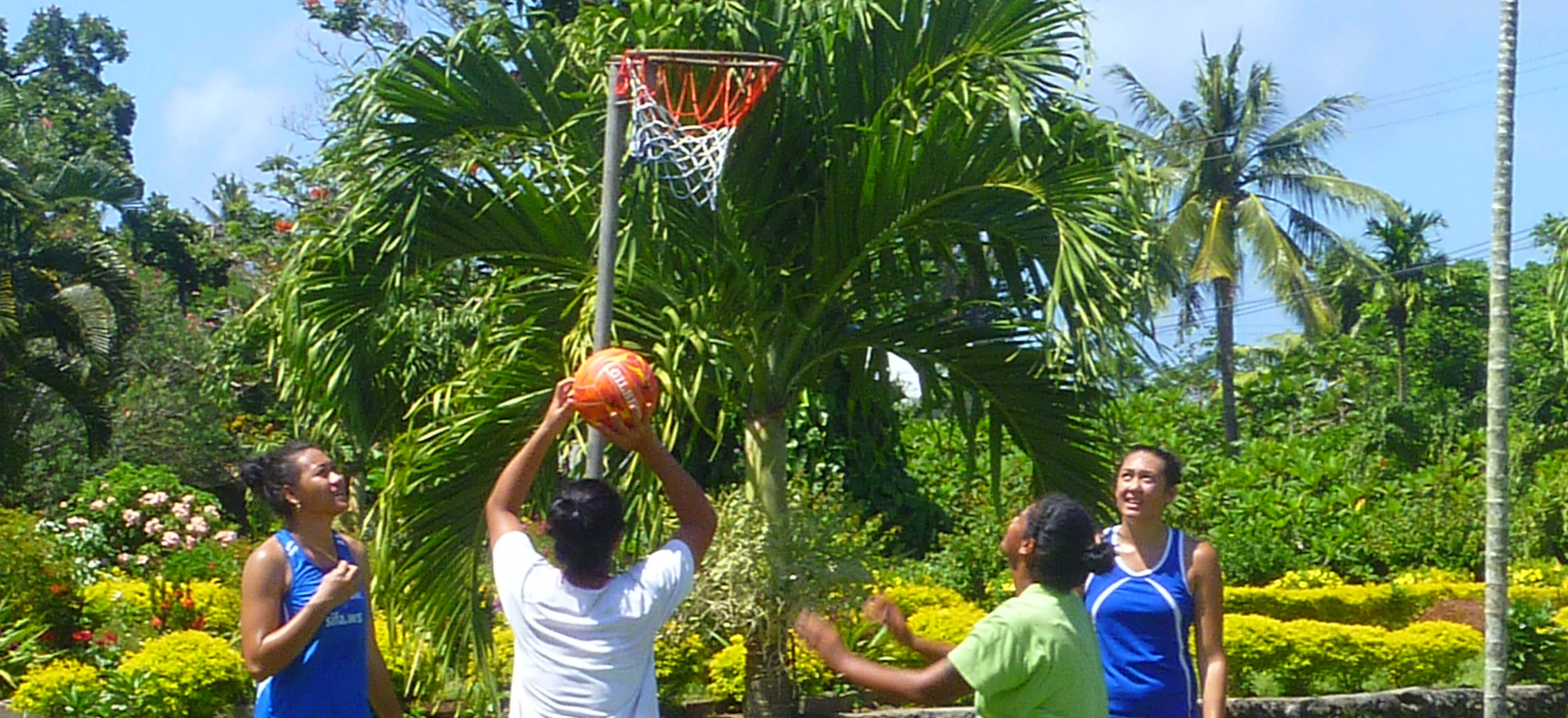 Young women shoot for goal in a netball training session