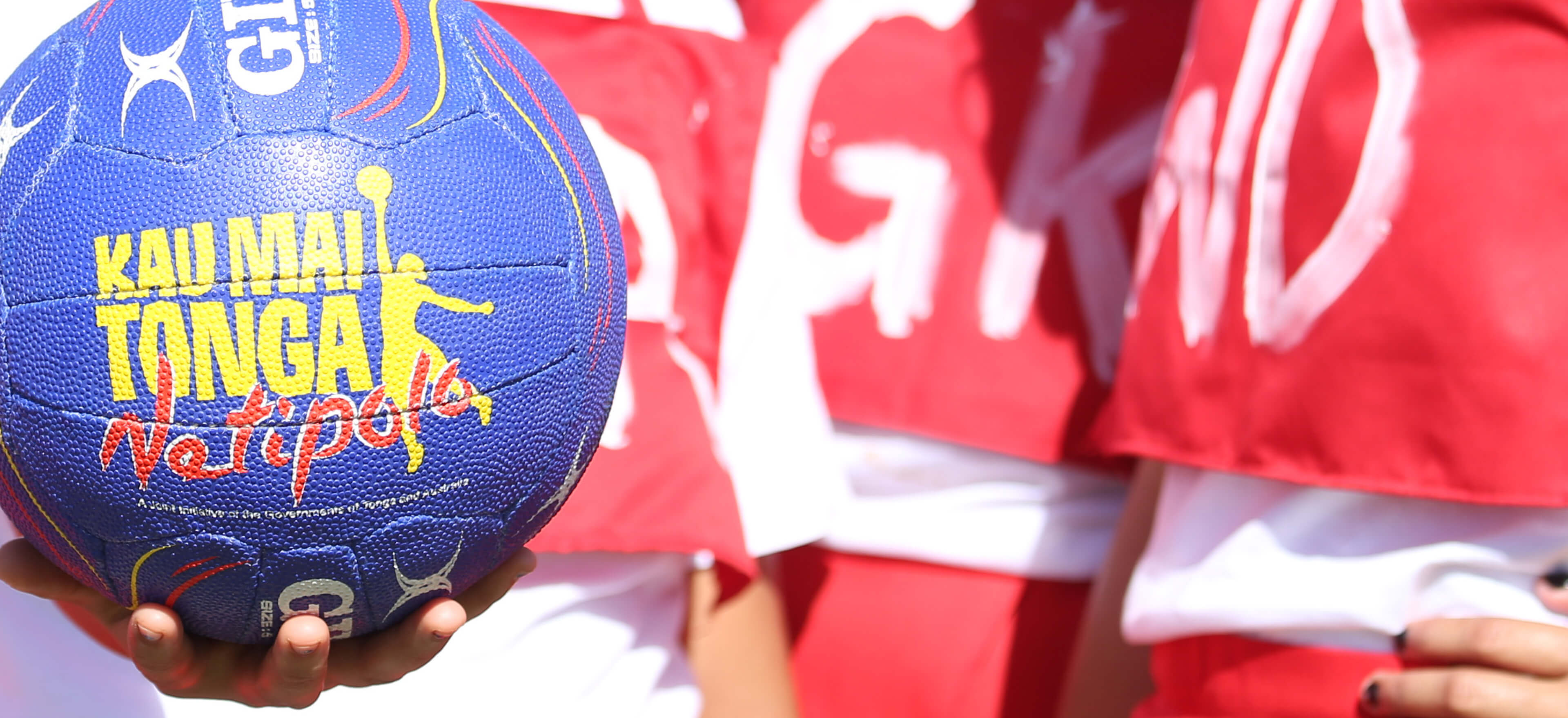 Young Tongan girl holds a netball