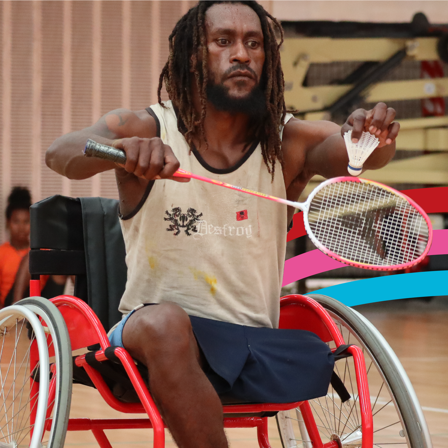 A man in a wheelchair in Papua New Guinea playing badminton 