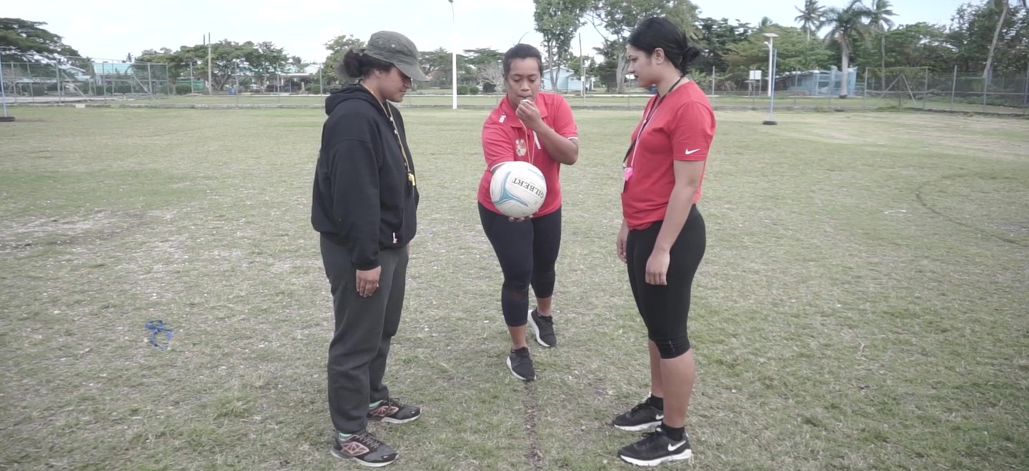 Three women in Tonga starting a netball match