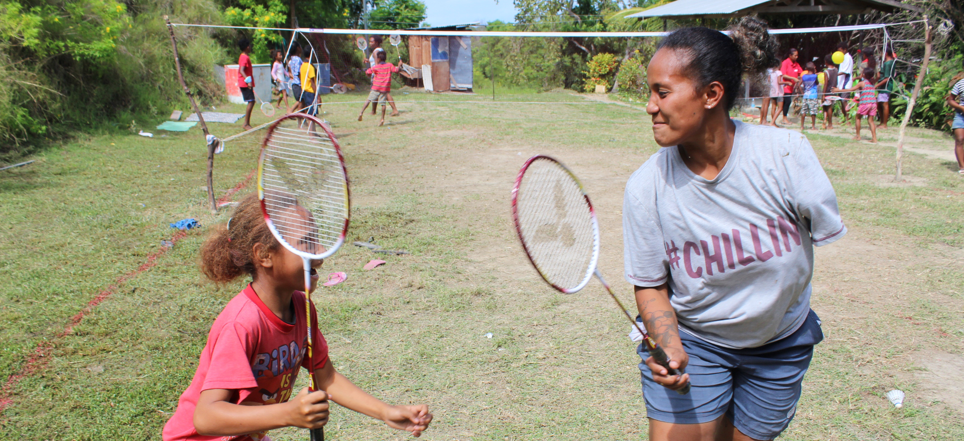 A woman and child holding badminton racquets in Papua New Guinea