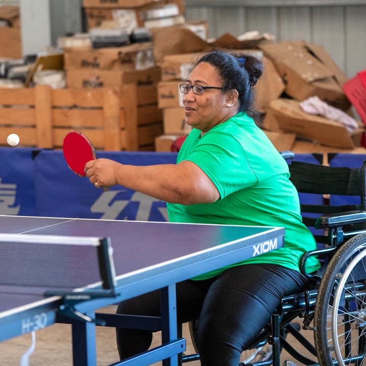 A woman in a wheelchair in Tonga playing table tennis