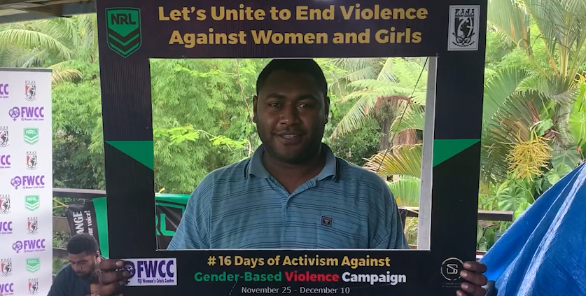 A man in Fiji holding a campaign photo frame 