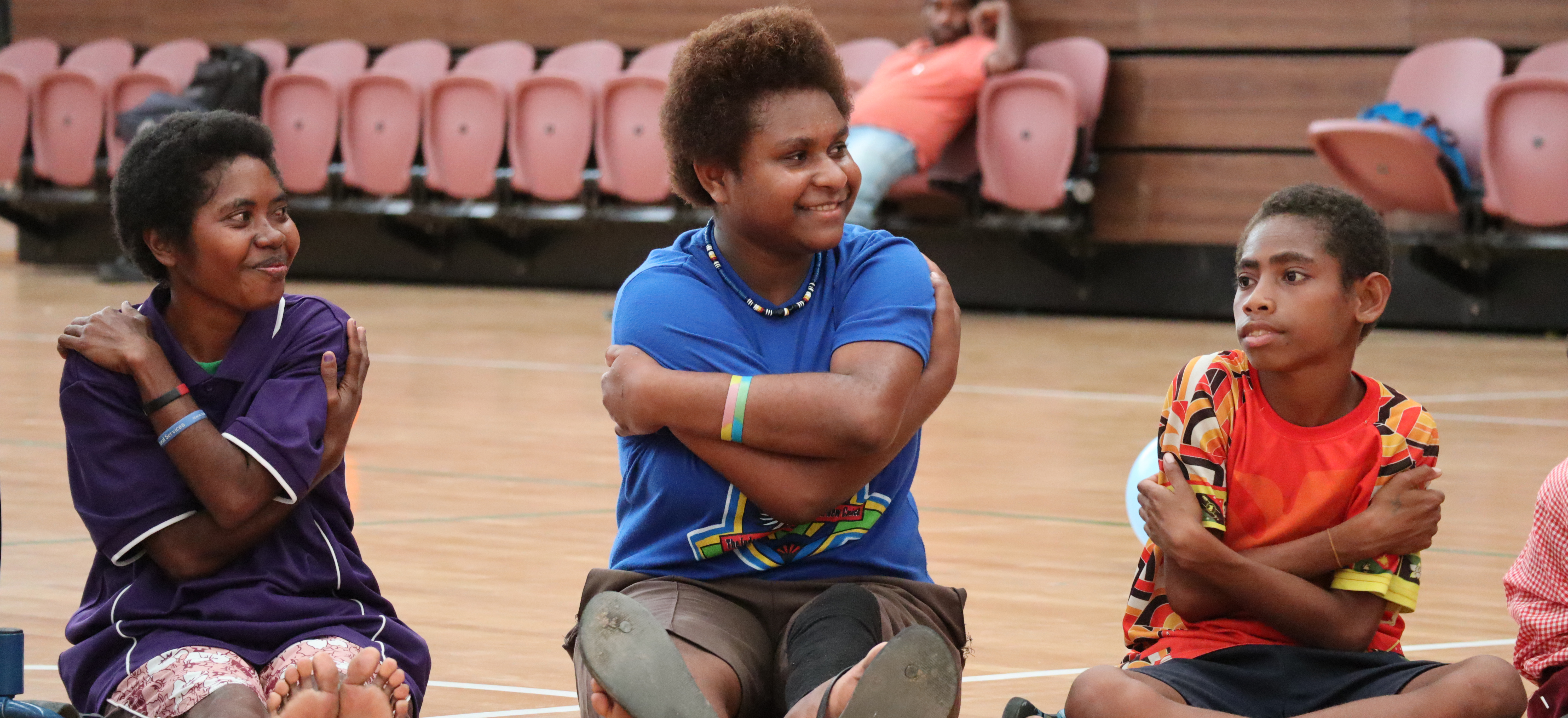 Children sitting in a sports hall in Papua New Guinea