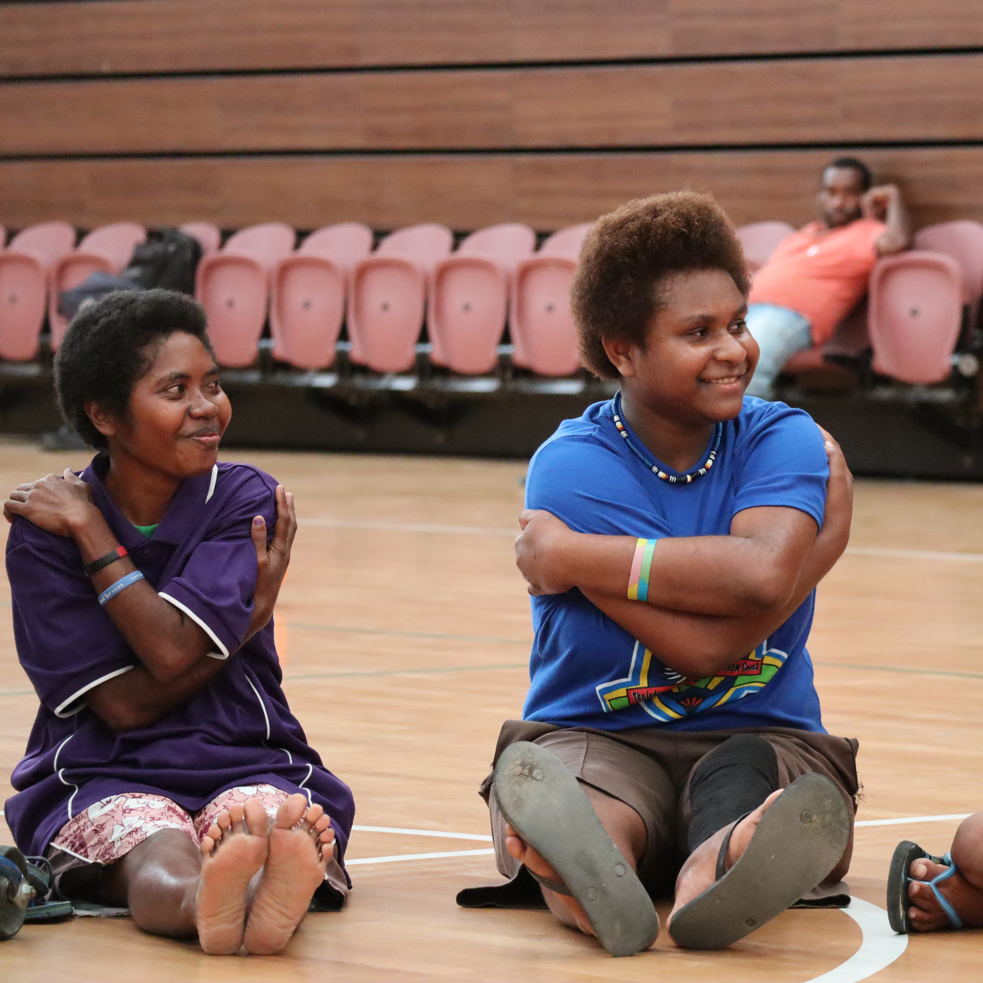 Children sitting in a sports hall in Papua New Guinea
