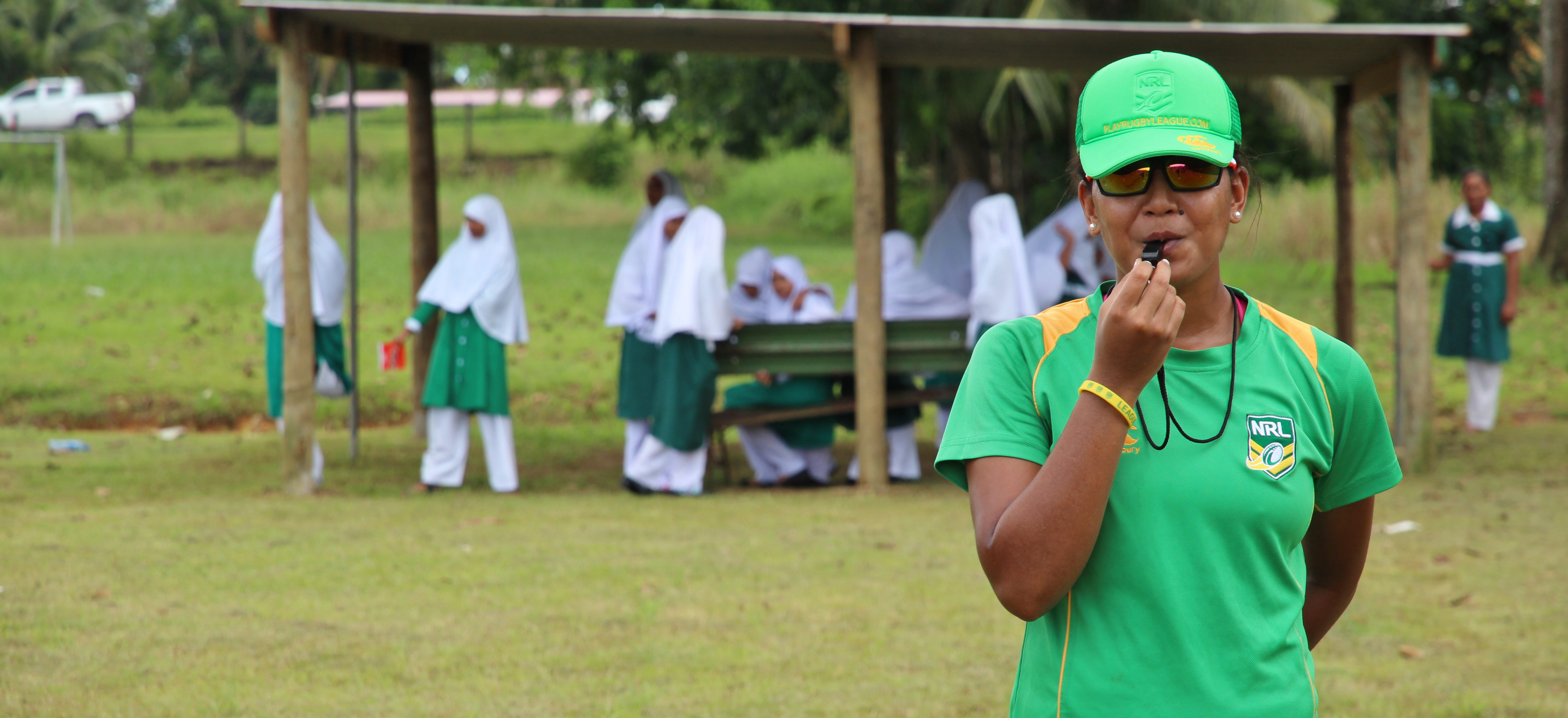 A woman in Fiji blowing a whistle