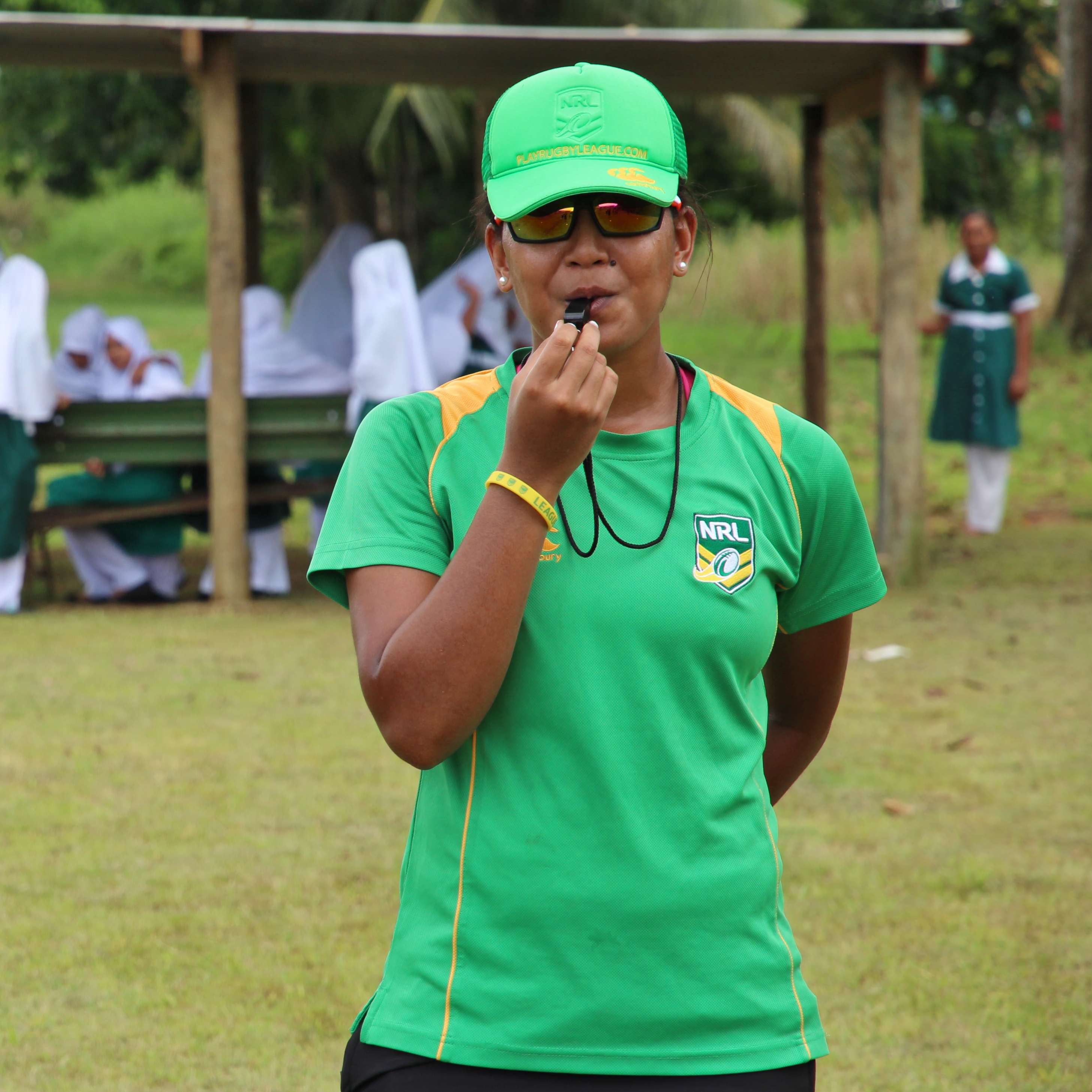 A woman in Fiji blowing a whistle 