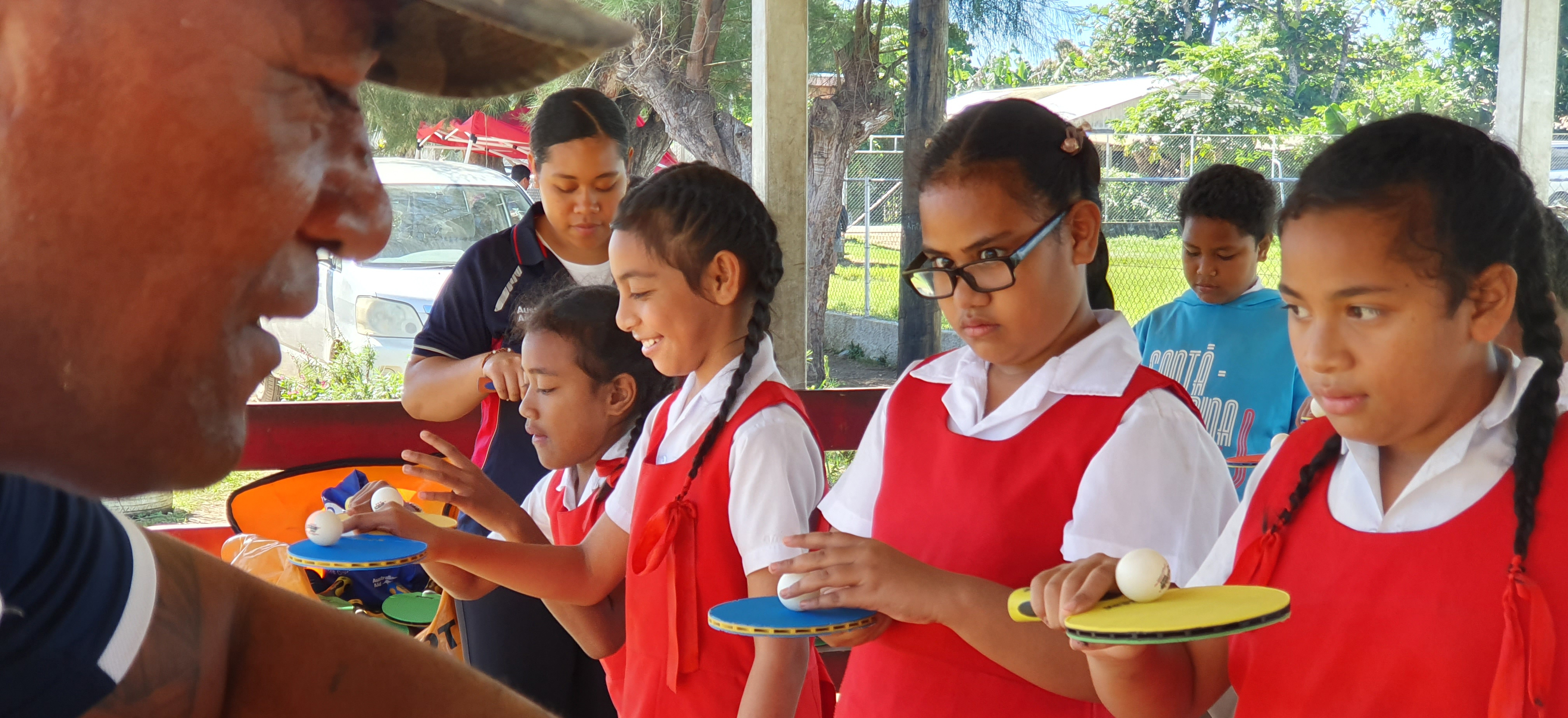 Children in Tonga learning table tennis skills