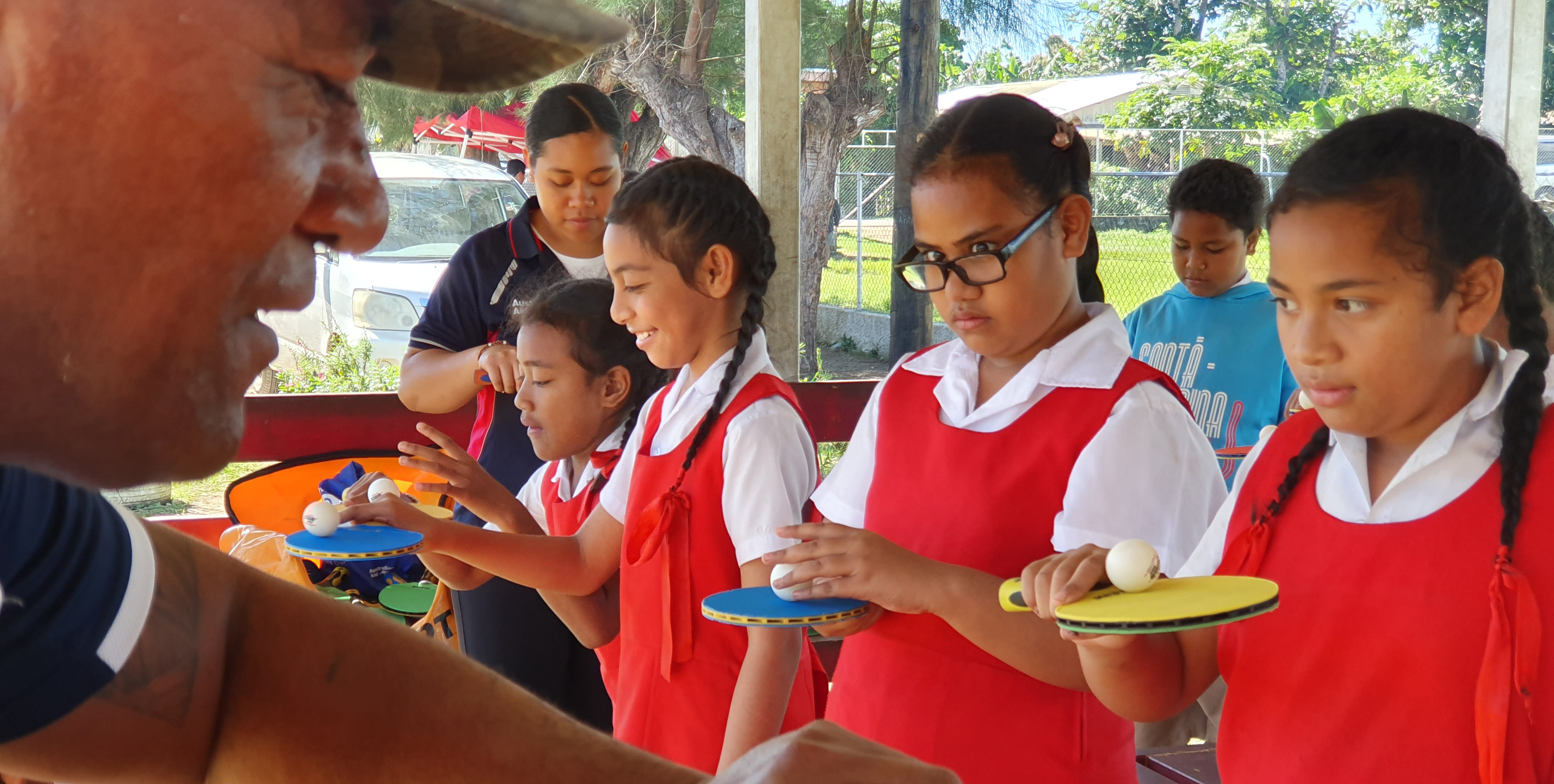 Children in Tonga learning table tennis skills