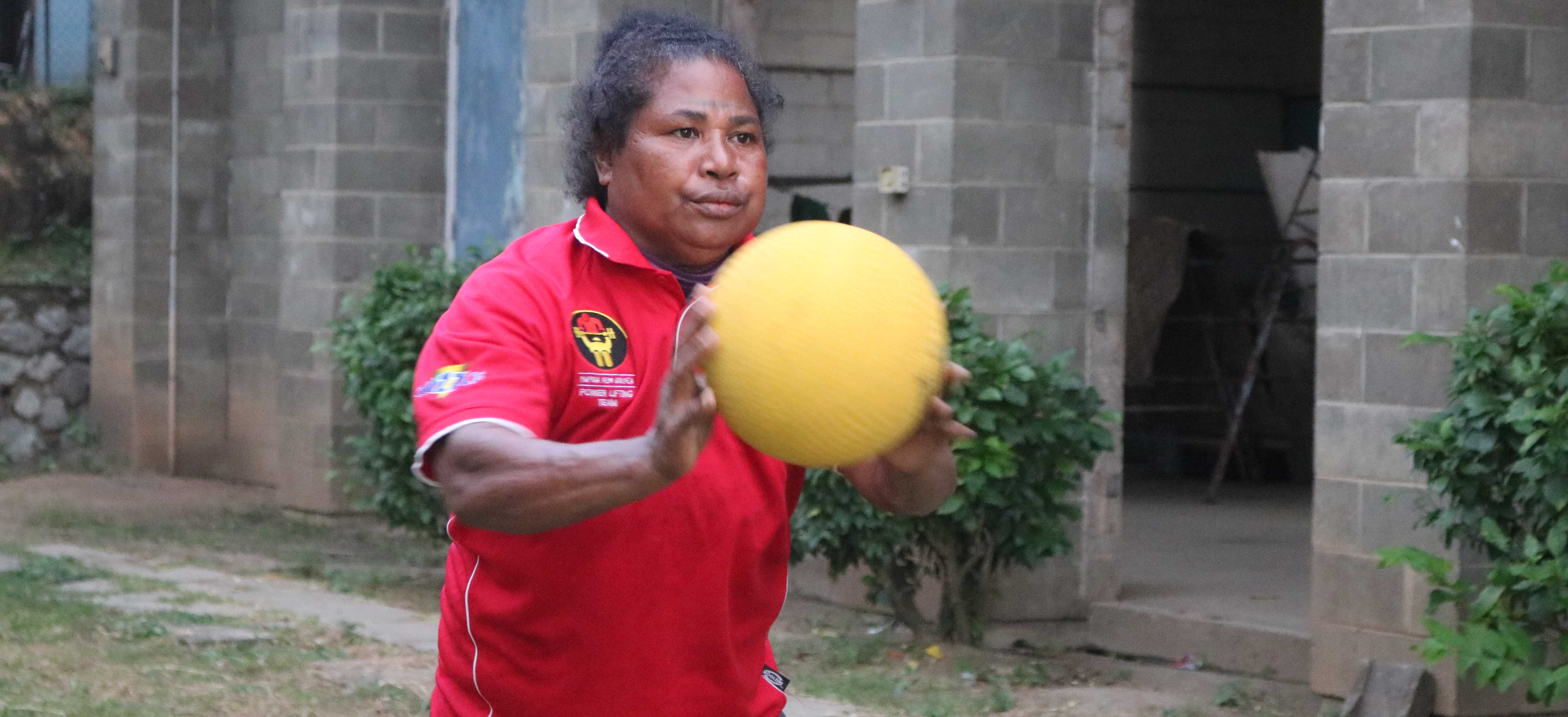 A woman in Papua New Guinea throwing a ball