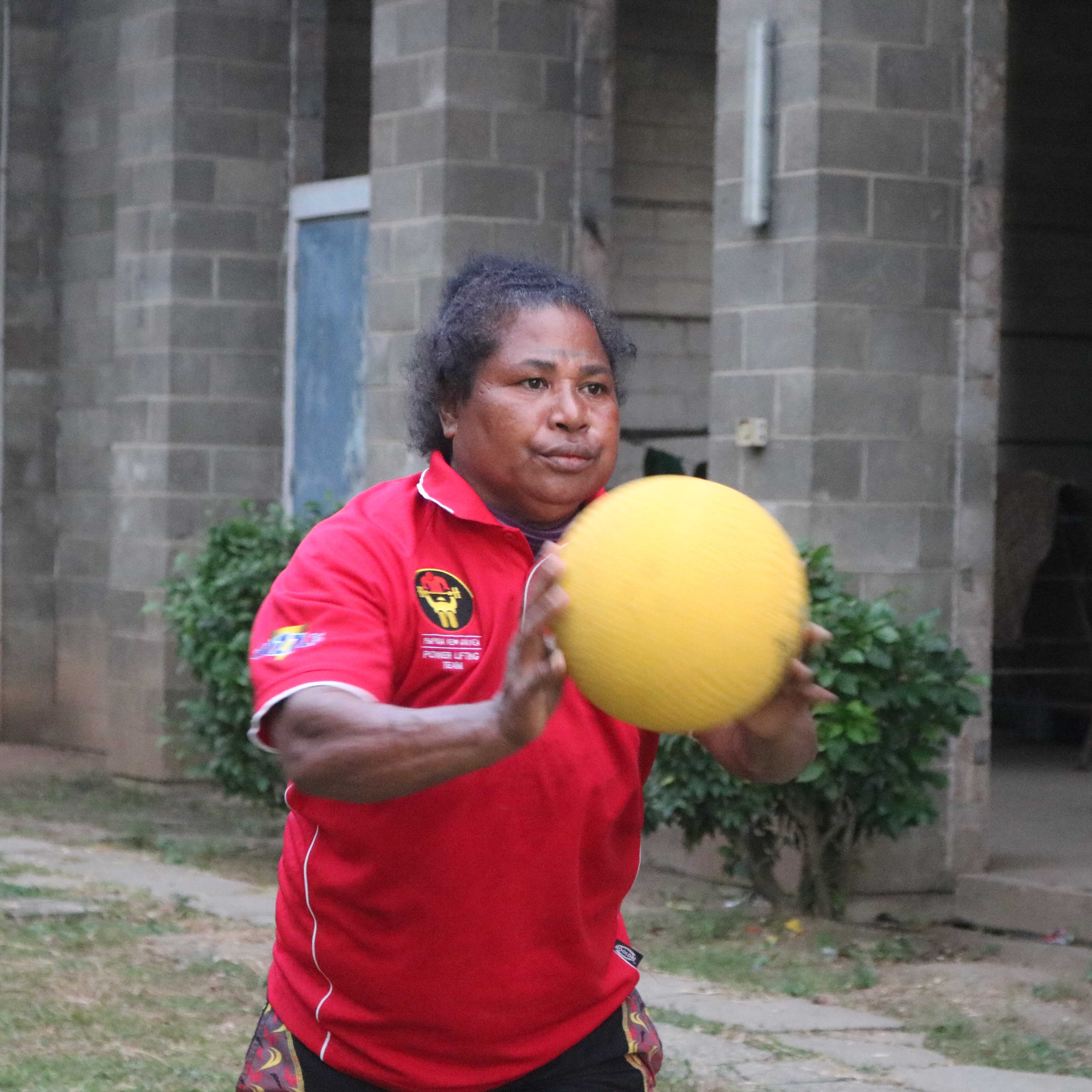 A woman in Papua New Guinea throwing a ball