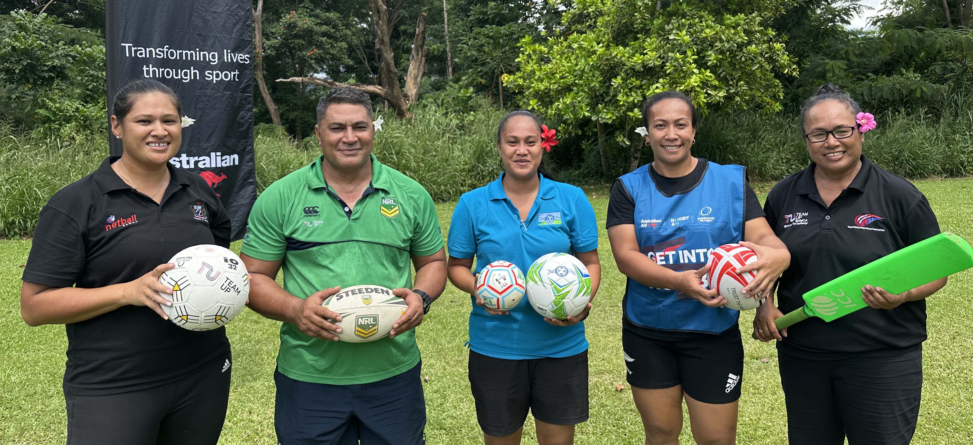 Managers of sport programs in Samoa smiling in a photo