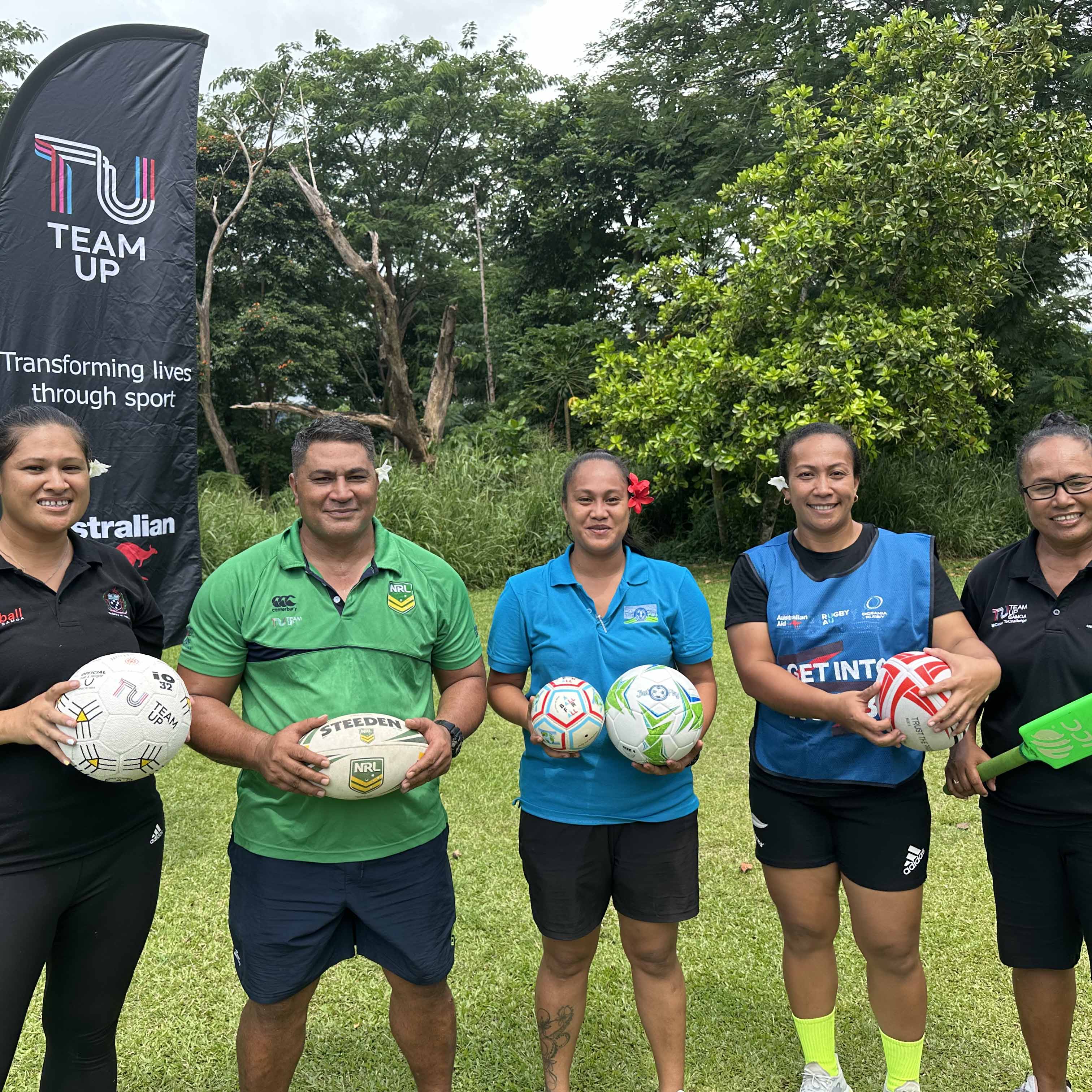 Managers of sport programs in Samoa smiling in a photo