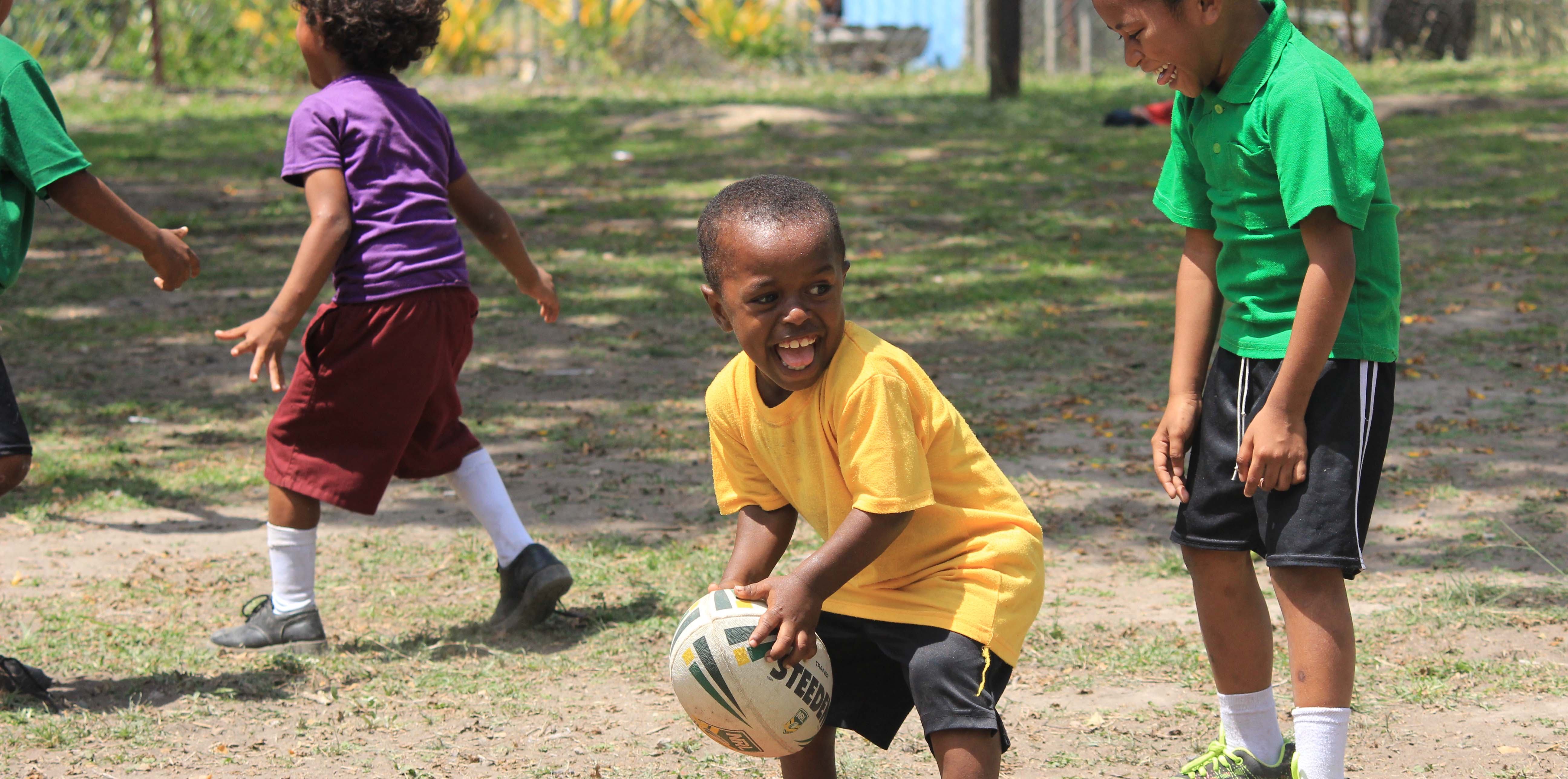 A boy in Papua New Guinea learning rugby league skills