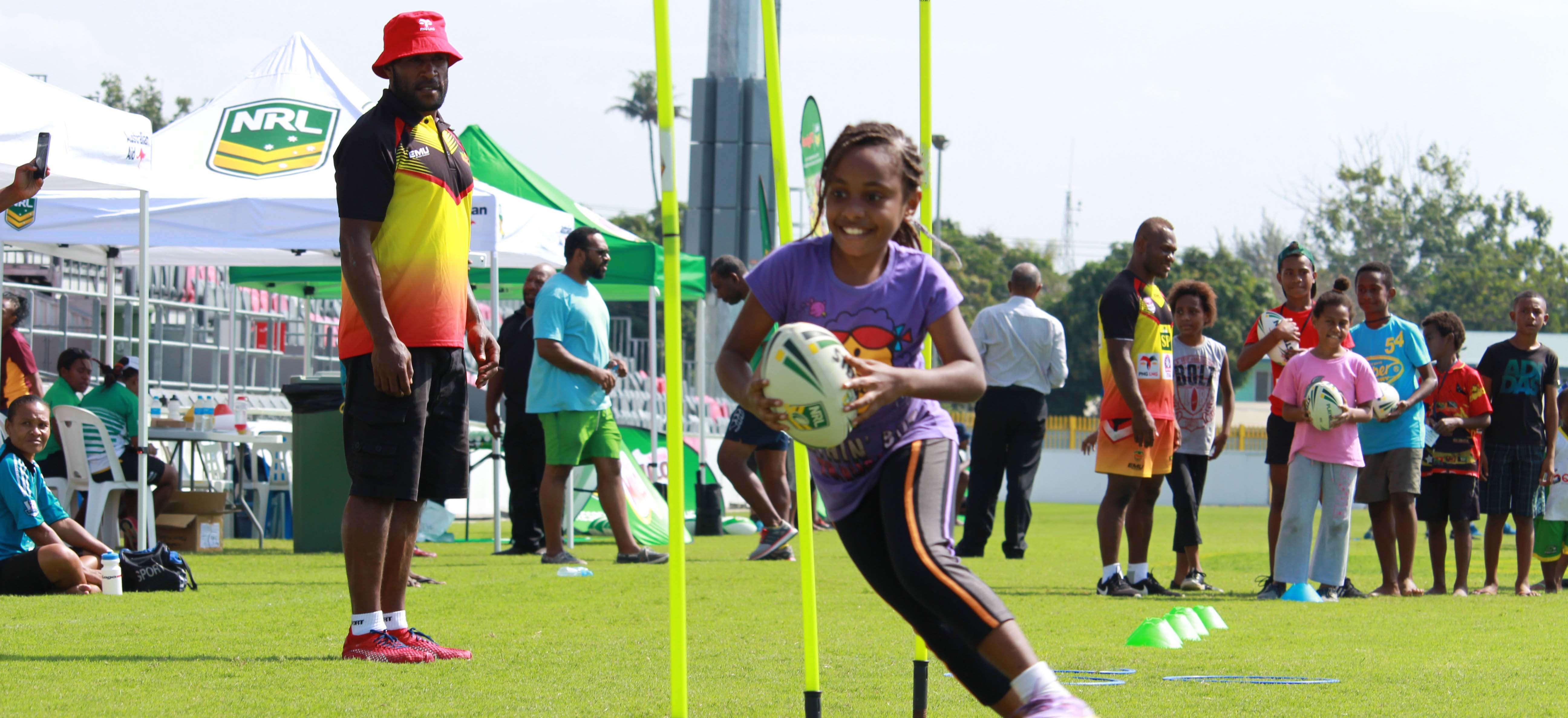 A girl in Papua New Guinea learning rugby league skills