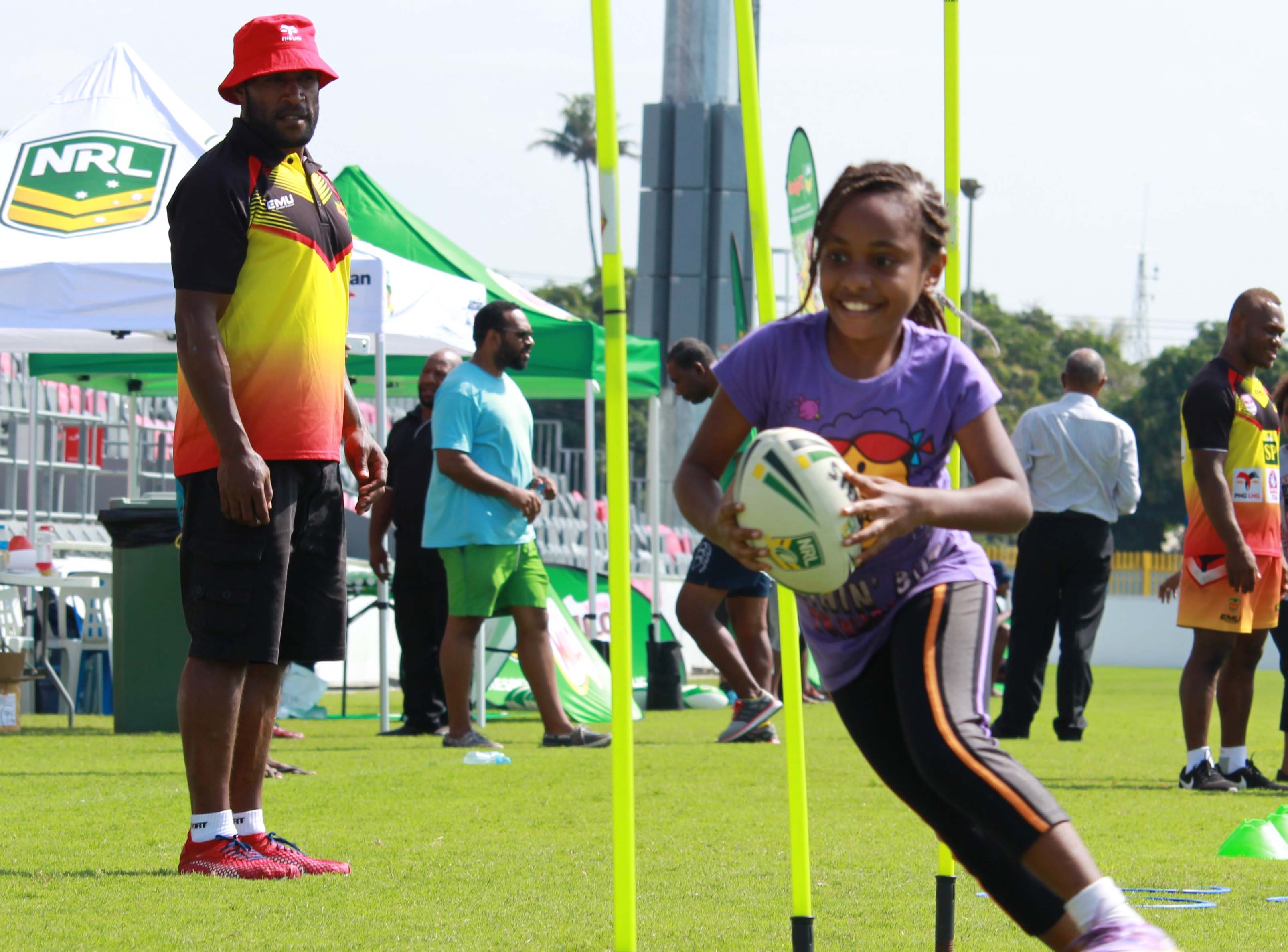 A girl in Papua New Guinea learning rugby league skills 
